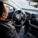 A driver in China demonstrates the functionality of an autonomous taxi.